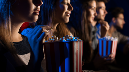 People eating popcorn in a movie theatre
