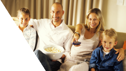 Family watching TV together with a bowl of popcorn
