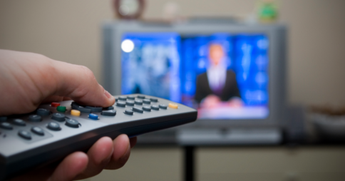Left hand pointing remote control towards TV. Image credit: flash.pro via Flickr