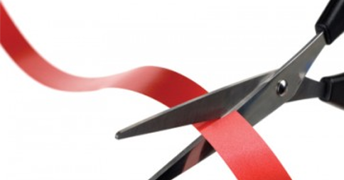 Scissors cutting through red tape
